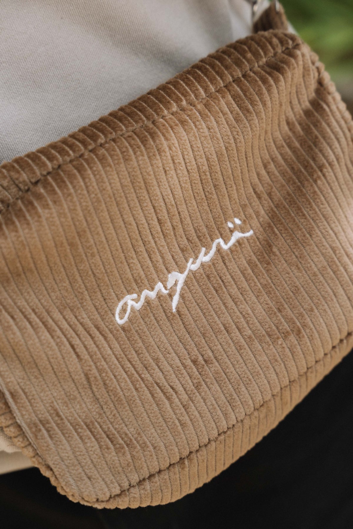 Camel corduroy crossbody bag, close-up of white angurä embroidery