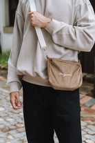 Camel corduroy crossbody bag, worn across the body