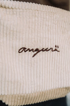 Cream corduroy crossbody bag, close-up of brown angurä embroidery