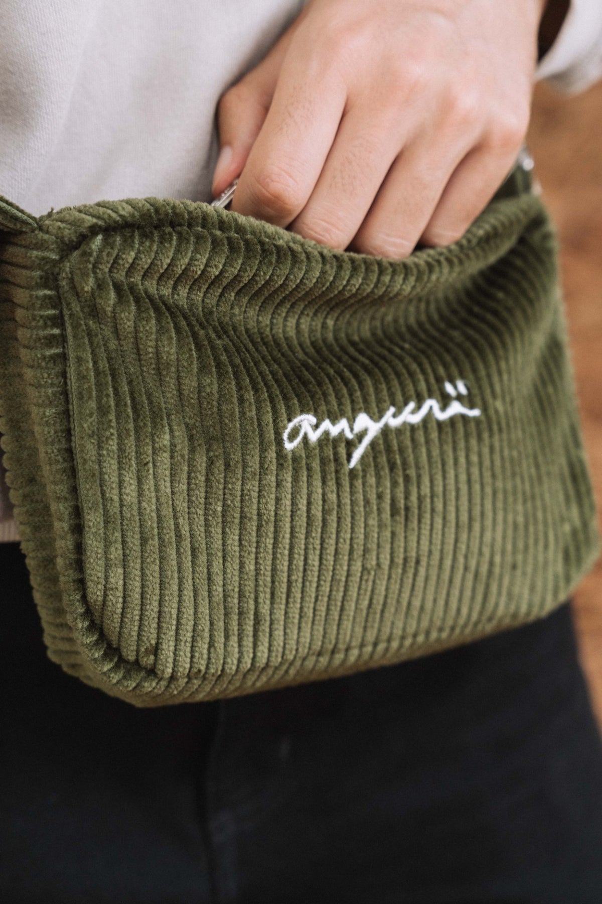 Khaki corduroy crossbody bag, close-up of white angurä embroidery